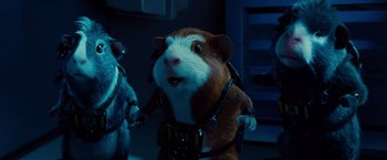 Movie still from “G-Force” (2009), directed by Hoyt Yeatman – A small hamster wearing a harness and holding a leash in a room; Medium shot, Low angle