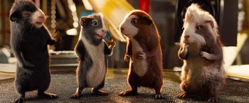 Movie still from “G-Force” (2009), directed by Hoyt Yeatman – A couple of hamsters standing next to each other on the ground; Medium shot, Low angle