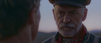 Movie still from “Gallipoli” (1981), directed by Peter Weir – An older man with a beard and a hat; Close Up shot, Low angle