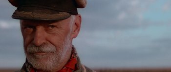 Movie still from “Gallipoli” (1981), directed by Peter Weir – An older man with a beard wearing a hat; Close Up shot, Low angle