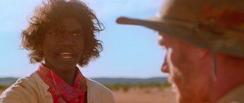 Movie still from “Gallipoli” (1981), directed by Peter Weir – A man and a woman talking to each other in the desert; Close Up shot, Over the shoulder angle