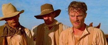 Movie still from “Gallipoli” (1981), directed by Peter Weir – A group of men standing next to each other on top of a hill; Close Up shot, Low angle