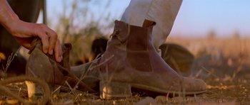 Movie still from “Gallipoli” (1981), directed by Peter Weir – A person's foot wearing a pair of boots; Extreme Close Up shot, Low angle