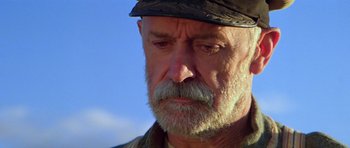 Movie still from “Gallipoli” (1981), directed by Peter Weir – An older man with a beard and a hat; Close Up shot, Low angle