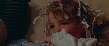 Movie still from “Gallipoli” (1981), directed by Peter Weir – A little girl with a bunch of hair on her head; Close Up shot, High angle