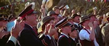 Movie still from “Gallipoli” (1981), directed by Peter Weir – A group of people wearing hats and holding up their hands in the air; Close Up shot, High angle