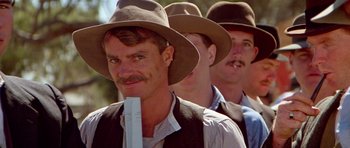 Movie still from “Gallipoli” (1981), directed by Peter Weir – A group of men wearing hats and vests; Close Up shot, Low angle
