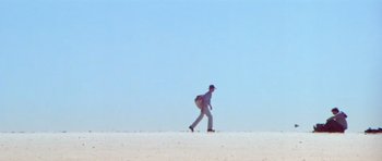 Movie still from “Gallipoli” (1981), directed by Peter Weir – A man walking across a snow covered field; Extreme Wide shot, Low angle