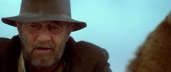 Movie still from “Gallipoli” (1981), directed by Peter Weir – An older man wearing a hat and a jacket; Close Up shot, Low angle