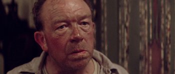 Movie still from “Gallipoli” (1981), directed by Peter Weir – An older man with a beard and a mustache; Close Up shot, Over the shoulder angle