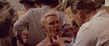 Movie still from “Gallipoli” (1981), directed by Peter Weir – A man getting his teeth brushed by a dentist; Close Up shot, Over the shoulder angle