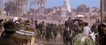 Movie still from “Gallipoli” (1981), directed by Peter Weir – A group of men on horses in the middle of the desert; Wide shot, High angle