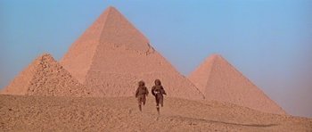 Movie still from “Gallipoli” (1981), directed by Peter Weir – A couple of people that are in the desert; Extreme Wide shot, Low angle