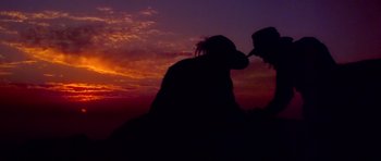 Movie still from “Gallipoli” (1981), directed by Peter Weir – Two people are silhouetted against a sunset; Extreme Wide shot, Low angle