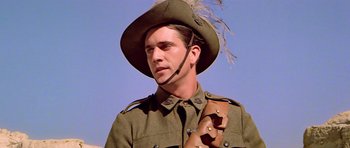 Movie still from “Gallipoli” (1981), directed by Peter Weir – A man in a military uniform with a pipe in his mouth; Close Up shot, Low angle
