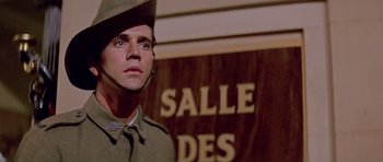 Movie still from “Gallipoli” (1981), directed by Peter Weir – A man wearing a hat and a military uniform; Close Up shot, Low angle