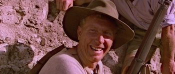 Movie still from “Gallipoli” (1981), directed by Peter Weir – A man wearing a hat smiling for the camera; Close Up shot, Low angle