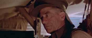 Movie still from “Gallipoli” (1981), directed by Peter Weir – An older man wearing a hat and a uniform; Close Up shot, Low angle