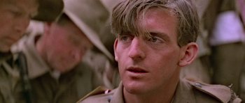 Movie still from “Gallipoli” (1981), directed by Peter Weir – A person wearing a military uniform; Close Up shot, Low angle