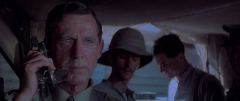 Movie still from “Gallipoli” (1981), directed by Peter Weir – A group of men standing next to each other in a room; Close Up shot, Over the shoulder angle