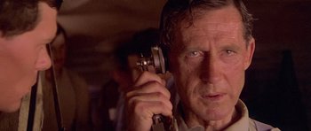 Movie still from “Gallipoli” (1981), directed by Peter Weir – An older man holding a phone up to his ear; Close Up shot, Low angle