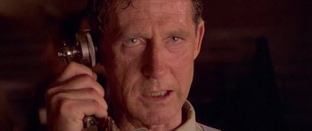 Movie still from “Gallipoli” (1981), directed by Peter Weir – An older man talking on a cell phone; Close Up shot, Low angle