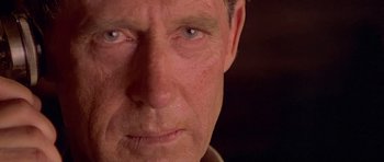 Movie still from “Gallipoli” (1981), directed by Peter Weir – A man's face with blue eyes; Extreme Close Up shot, Over the shoulder angle