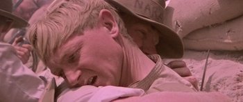 Movie still from “Gallipoli” (1981), directed by Peter Weir – A person wearing a hat; Close Up shot, Over the shoulder angle