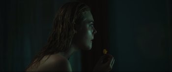 Movie still from “Galveston” (2018), directed by Mélanie Laurent – A man with long hair is eating a piece of fruit; Close Up shot, Over the shoulder angle