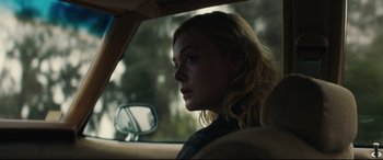 Movie still from “Galveston” (2018), directed by Mélanie Laurent – A woman sitting in the driver's seat of a car looking out the window; Close Up shot, Over the shoulder angle