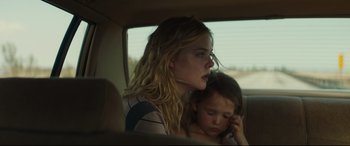 Movie still from “Galveston” (2018), directed by Mélanie Laurent – A young girl sitting in the back seat of a car with her mother; Close Up shot, Over the shoulder angle