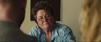 Movie still from “Galveston” (2018), directed by Mélanie Laurent – An older woman wearing glasses and a plaid shirt; Close Up shot, Over the shoulder angle