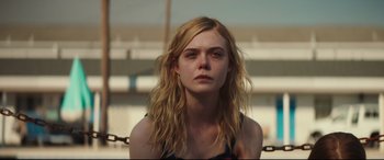 Movie still from “Galveston” (2018), directed by Mélanie Laurent – A woman with long blonde hair is staring straight ahead; Close Up shot, Over the shoulder angle