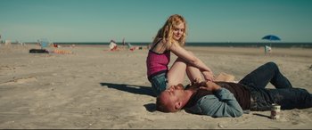 Movie still from “Galveston” (2018), directed by Mélanie Laurent – A man and a woman on the beach; Medium shot, High angle