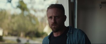 Movie still from “Galveston” (2018), directed by Mélanie Laurent – A person with a beard looking at the camera; Close Up shot, Over the shoulder angle