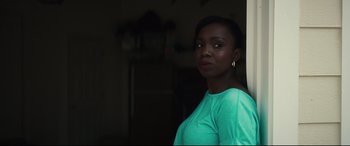 Movie still from “Galveston” (2018), directed by Mélanie Laurent – A woman in a green shirt is posing for a picture; Close Up shot, Over the shoulder angle