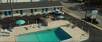 Movie still from “Galveston” (2018), directed by Mélanie Laurent – An aerial view of a motel with a swimming pool; Extreme Wide shot, High angle