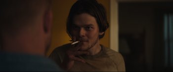 Movie still from “Galveston” (2018), directed by Mélanie Laurent – A man smoking a cigarette in front of a mirror; Close Up shot, Over the shoulder angle