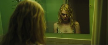 Movie still from “Galveston” (2018), directed by Mélanie Laurent – A woman looking in the mirror in a bathroom; Close Up shot, Over the shoulder angle