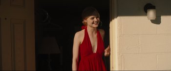 Movie still from “Galveston” (2018), directed by Mélanie Laurent – A woman in a red dress standing next to a wall; Medium shot, Over the shoulder angle