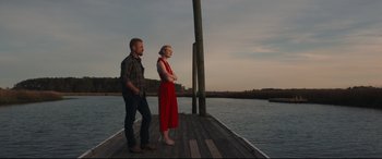 Movie still from “Galveston” (2018), directed by Mélanie Laurent – A man and a woman standing on a pier; Wide shot, Low angle