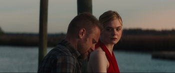 Movie still from “Galveston” (2018), directed by Mélanie Laurent – A man and a woman standing next to each other near a body of water; Close Up shot, Over the shoulder angle