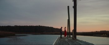 Movie still from “Galveston” (2018), directed by Mélanie Laurent – A man and a woman standing on a pier; Extreme Wide shot, Low angle