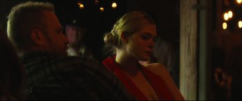 Movie still from “Galveston” (2018), directed by Mélanie Laurent – A woman in a red dress is looking at the camera; Close Up shot, Over the shoulder angle