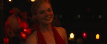 Movie still from “Galveston” (2018), directed by Mélanie Laurent – A beautiful young lady wearing a red dress; Close Up shot, Over the shoulder angle