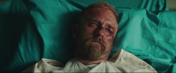 Movie still from “Galveston” (2018), directed by Mélanie Laurent – A person laying in a hospital bed; Close Up shot, Overhead angle