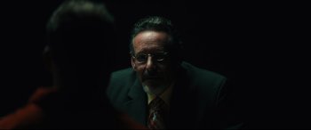 Movie still from “Galveston” (2018), directed by Mélanie Laurent – A person wearing a suit and tie; Close Up shot, Over the shoulder angle