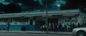Movie still from “Galveston” (2018), directed by Mélanie Laurent – A group of people standing on the side of the street; Extreme Wide shot, Over the shoulder angle