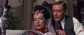 Movie still from “Gambit” (1966), directed by Ronald Neame – A man and a woman looking at each other; Close Up shot, Over the shoulder angle