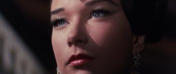 Movie still from “Gambit” (1966), directed by Ronald Neame – A woman's face with long eyelashes; Extreme Close Up shot, Low angle